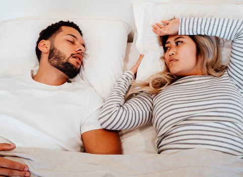 Man snores next to woman