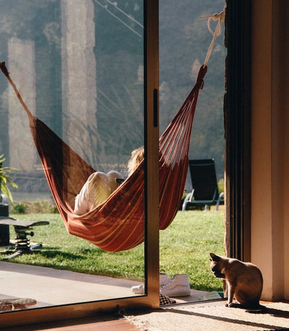 person relaxing in hammock