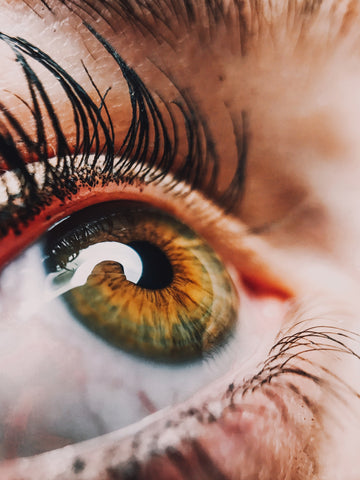 A close up of a woman's eye looking into the light.