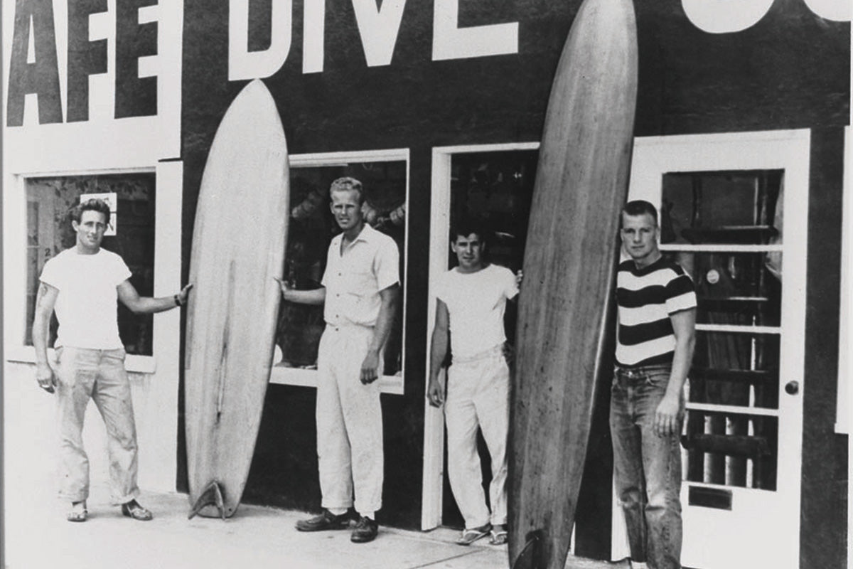 Dale Velzy, Hap Jacobs, Bill Meistral and bev morgan outide dive n surf surfshop in 1955 by surfing heritage and culture centre 