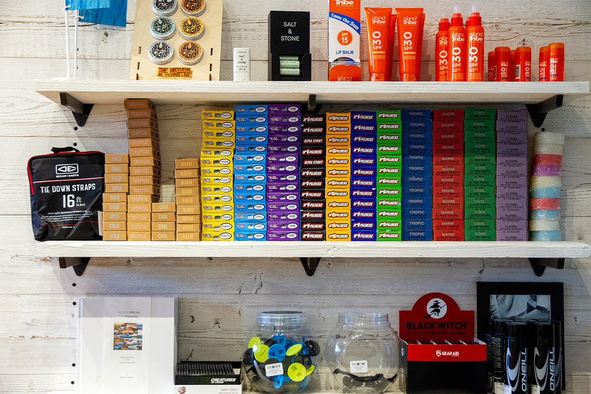 shelf of surf wax at down the line surf shop, cornwall