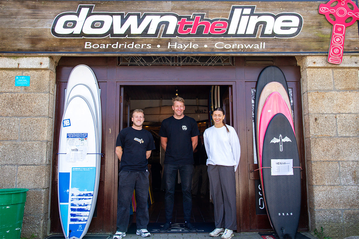 manager and team in the doorway of down the line surf shop in hayle, cornwall