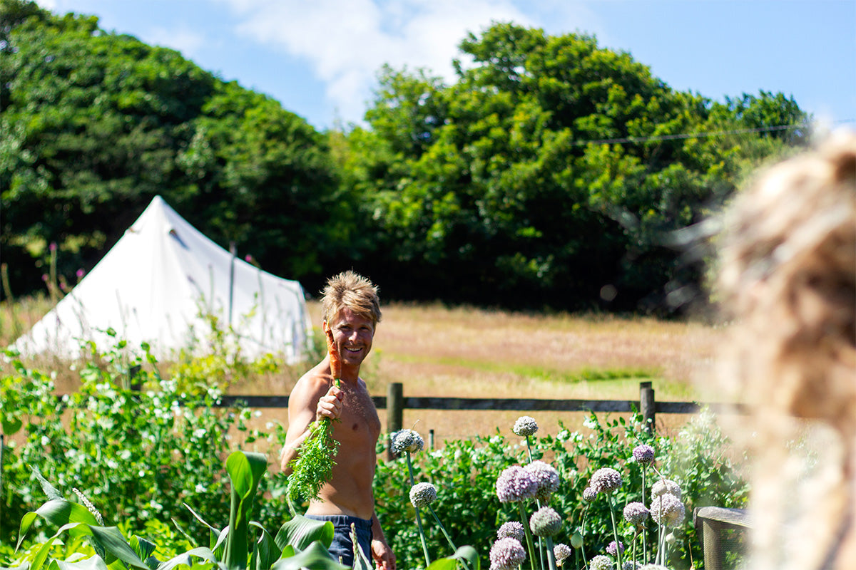 professional surfer jayce robinson picking carrots in his garden