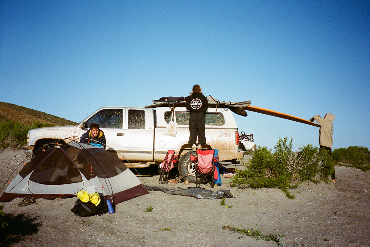 packing the truck during a surfing and camping trip in baja mexico