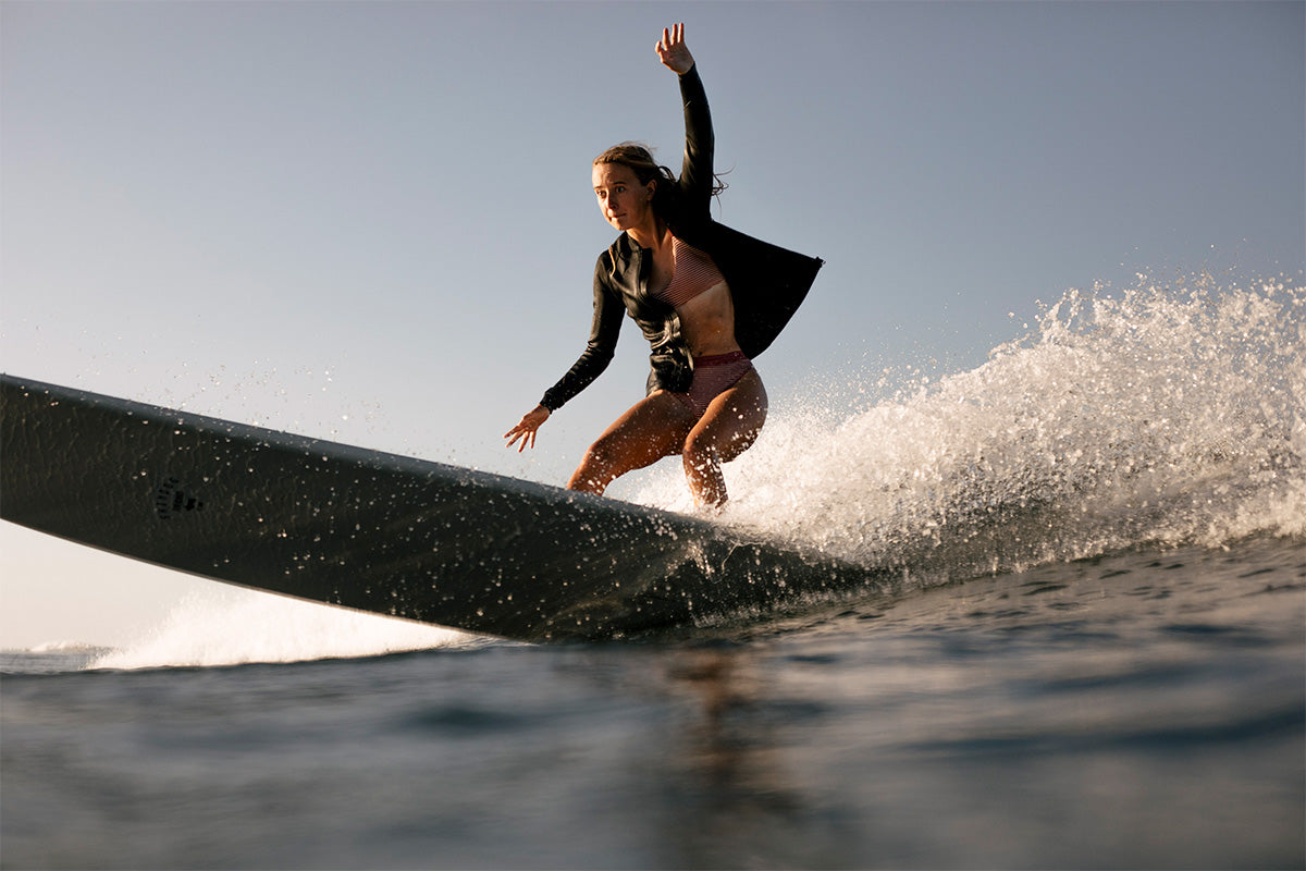 surfer beth leighfield cutting back on a longboard in mexico