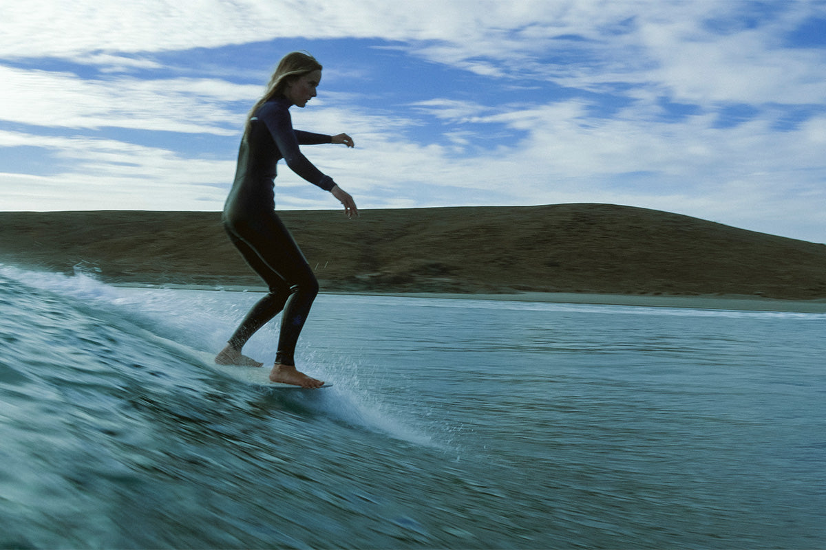 surfer beth leighfield noseriding at sunset on a surftrip in baja mexico