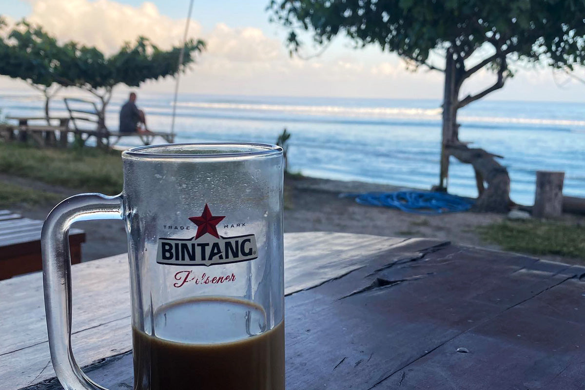 morning coffee in a bintang beer glass overlooking desert point