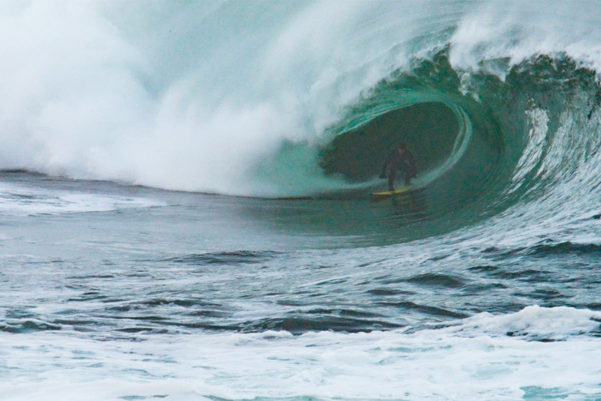 surfer ollie o'flaherty in the barrel at riley's in ireland