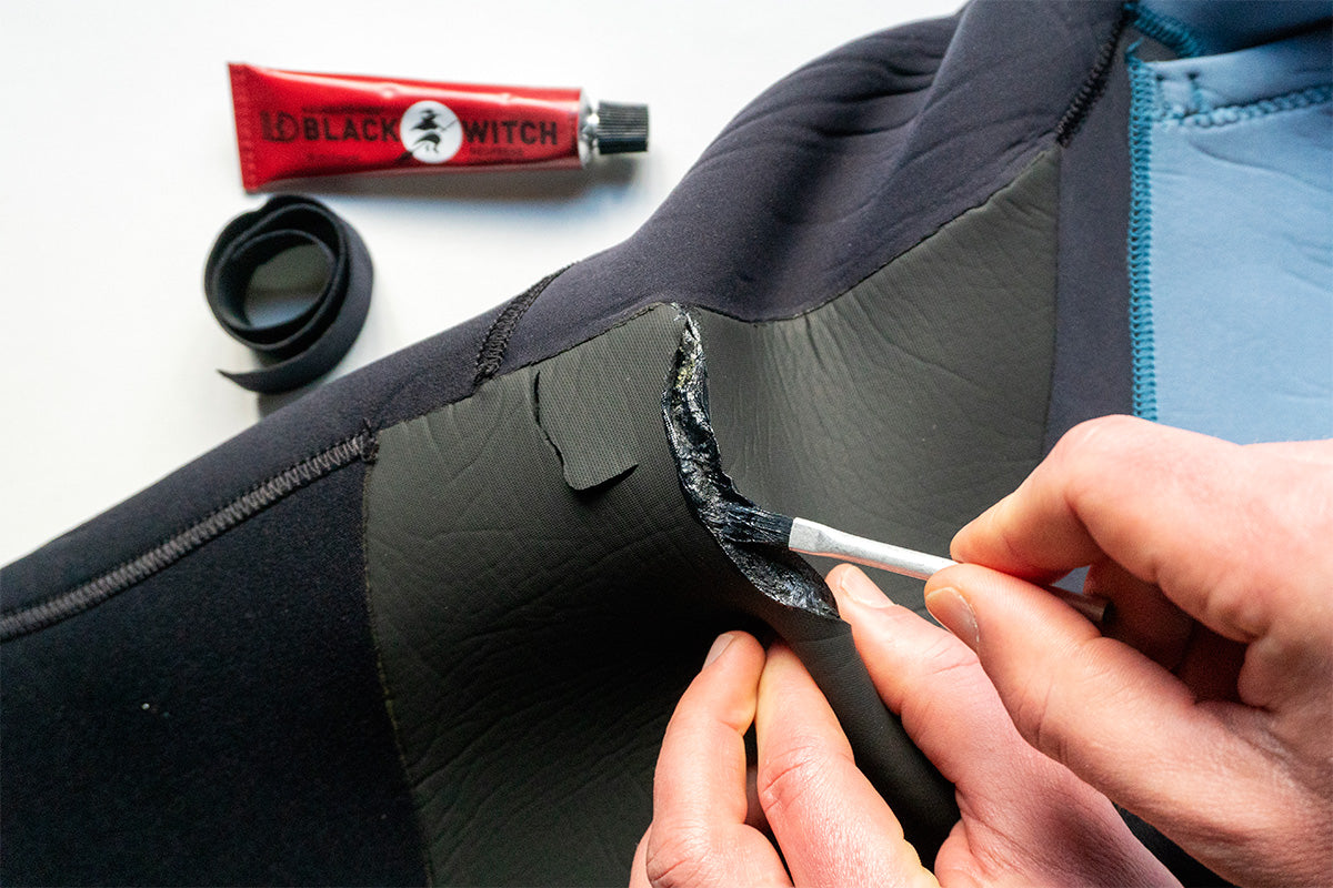 using neoprene adhesive to repair a split in a wetsuit