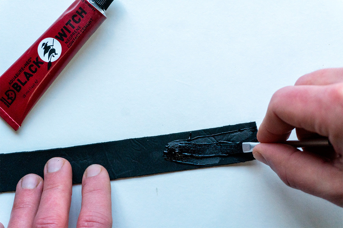 gluing a piece of neoprene tape to repair a wetsuit