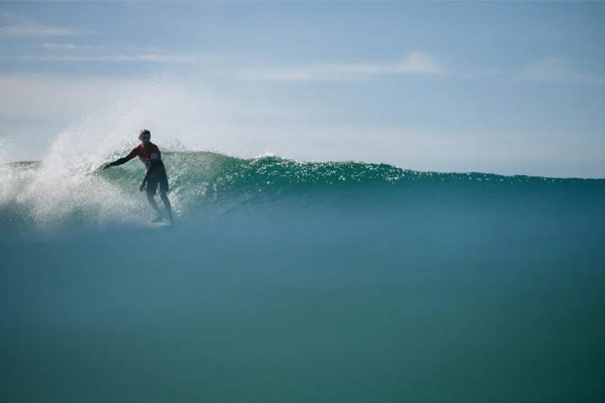 edouard delpero competing in a longboard surfing competition