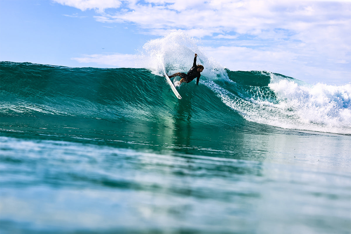 surfer wade carmichael carving off the top on a right hand point break wave on the gold coast, photographed by swilly