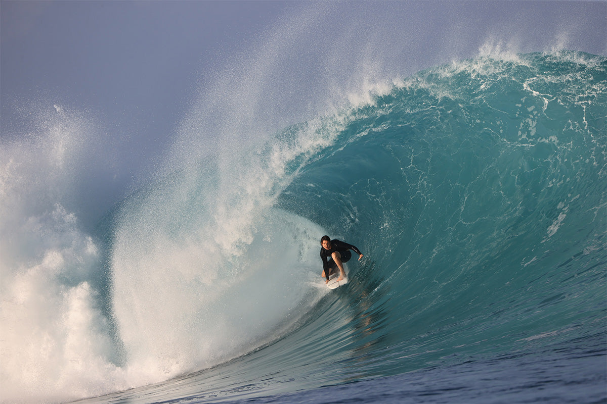 australian surfer billy kean in the barrel on a big left hand wave in indonesia, photograhed by swilly