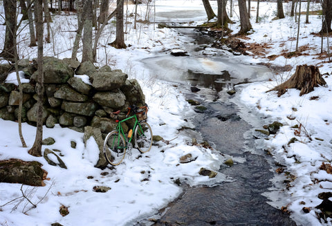 bike near brook in snow