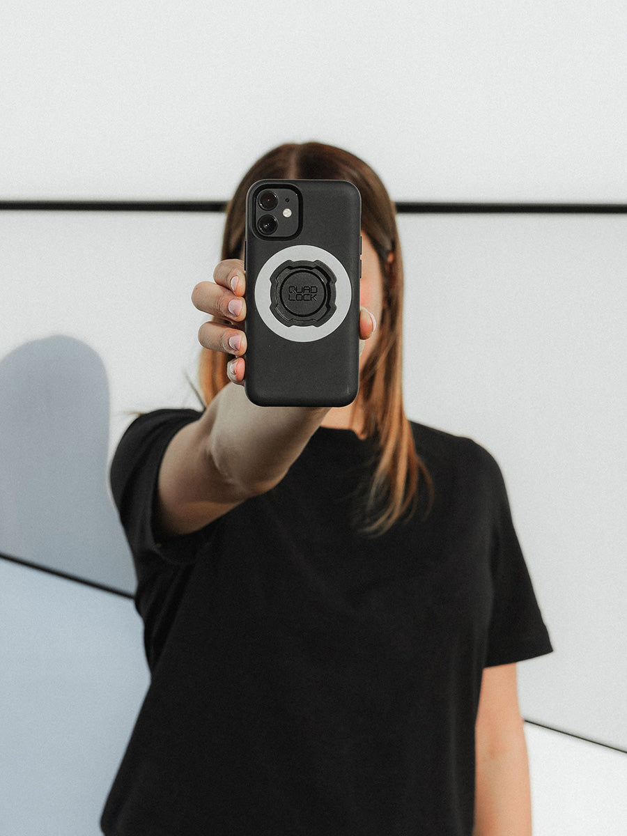 photo of person holding iPhone MAG case with Grey ring in front of their face