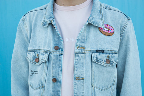 Man Wearing Denim Jacket Upcycled With Pink Donut Patch