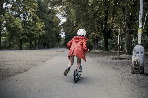 Girl riding a scooter on a pathway