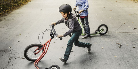 Kids learning to ride a scooter