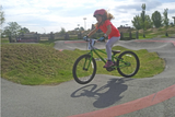 Girl riding Cleary Owl at the Nanaimo Velosolutions pump track at Steve Smith Bike Park