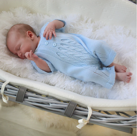 baby wearing light blue cropped knitted sleepsuit