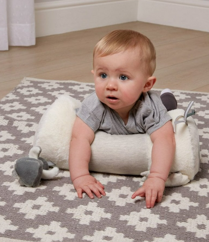 Baby laid on front on cushion