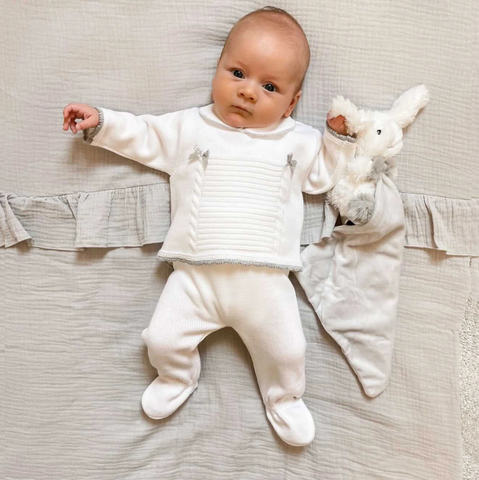 Baby in white and grey knitted clothes set
