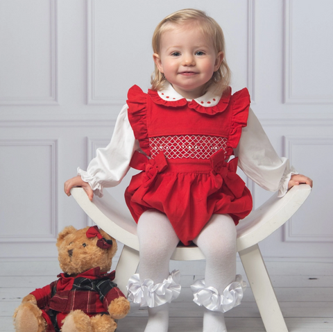Little girl in red corduroy christmas outfit