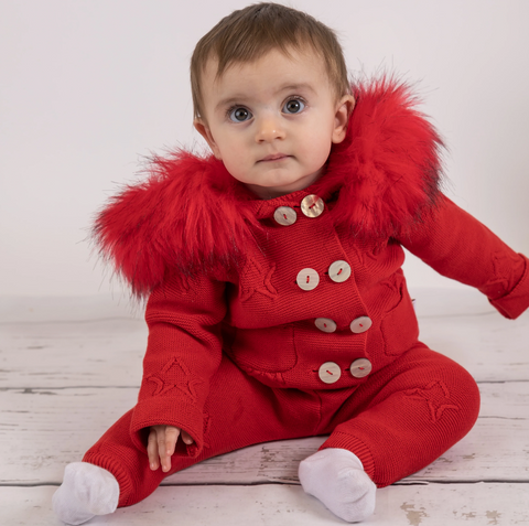 Baby wearing red knitted outfit