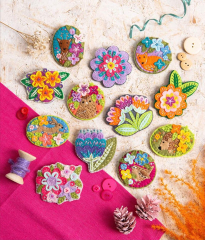 Display of handmade felt brooches. Some are floral, some are animals