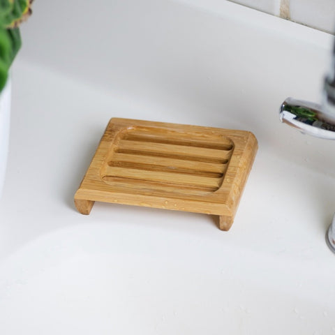 Bamboo soap deck on a white porcelain sink