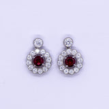 Silver Created Ruby with a halo of cubic zirconia Drop Earrings