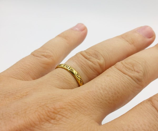 pure gold wedding ring on finger