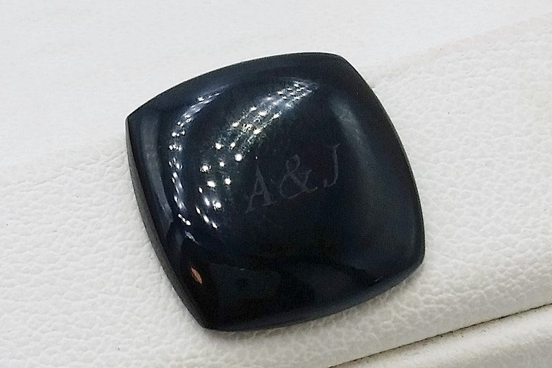 engraving of initials on black onyx stone