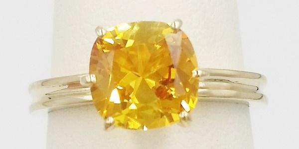 yellow gold ring set with a natural yellow sapphire cushion cut