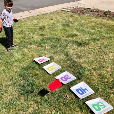 Kids Playing Bean Bag Toss Field Day At Home
