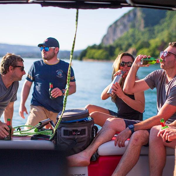 Friends sat around a 30L cooler bag enjoying a drink