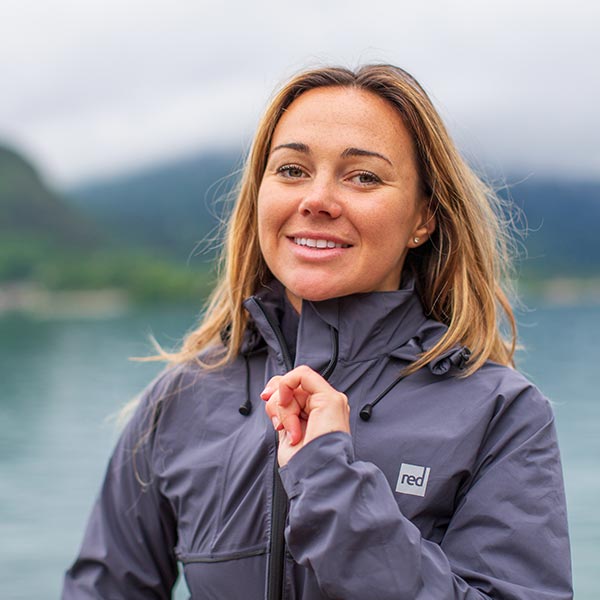 Woman doing up the zip on her waterproof active jacket