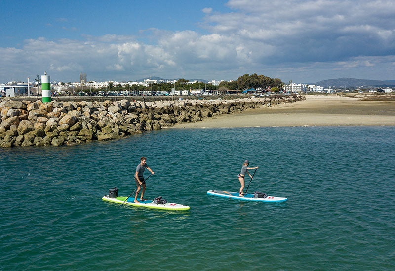 2 People Paddle Boarding On A Sunny Day
