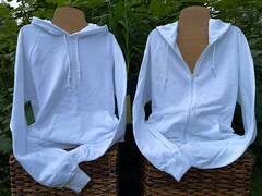 Two blank white hoodies, a zip-up and a pullover style, displayed next to one another on wooden mannequins