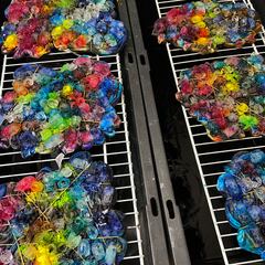 Four psychedelic mindscape tees in the making, covered with ice and rainbow colored fiber reactive dye powder