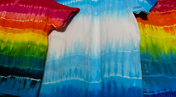 Three different horizontal striped, ombre gradient tie dye shirt designs hanging next to one another