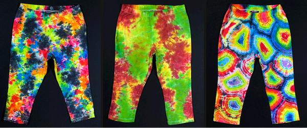 Collage featuring three pairs of custom tie dyed leggings, in designs (from left to right): rainbow with black splatter pattern, rainbow geode, and rasta splatter 