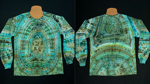 A side-by-side collage featuring both the front and back side of a size large long sleeve shirt featuring one single geode on the front side and two geode-like shapes on the back side, in a dreamy array of jewel-toned teals & seafoam greens