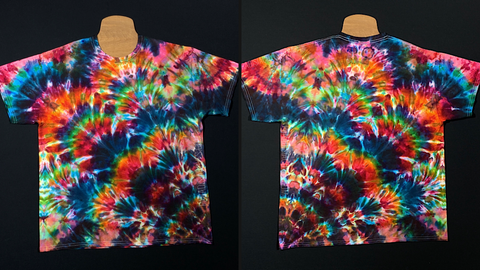 Front & back side of my first ever attempt at a lotus flower / star flower tie dye technique. Featuring a rainbow color scheme with a mandala like pattern radiating outward from the bottom right side