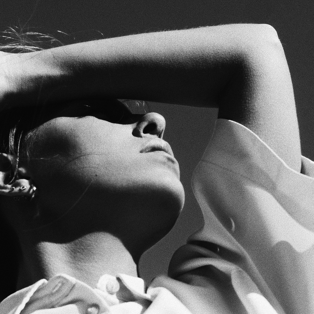 woman shielding her face from the sun