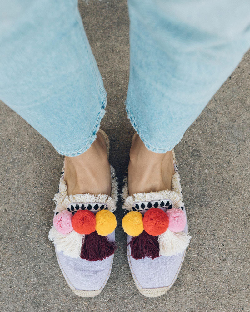 mules with pom poms