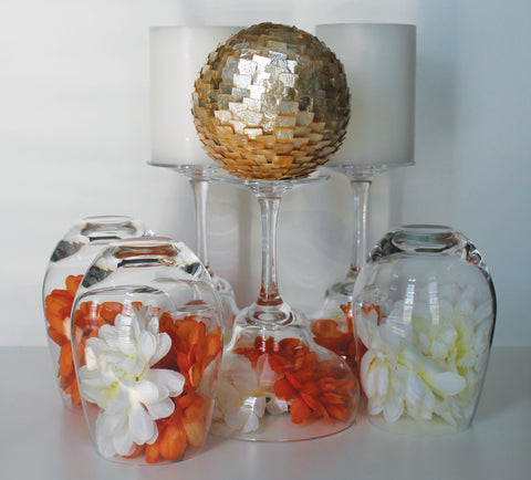 centrepiece made with stemware and flowers, with candles and ball decor