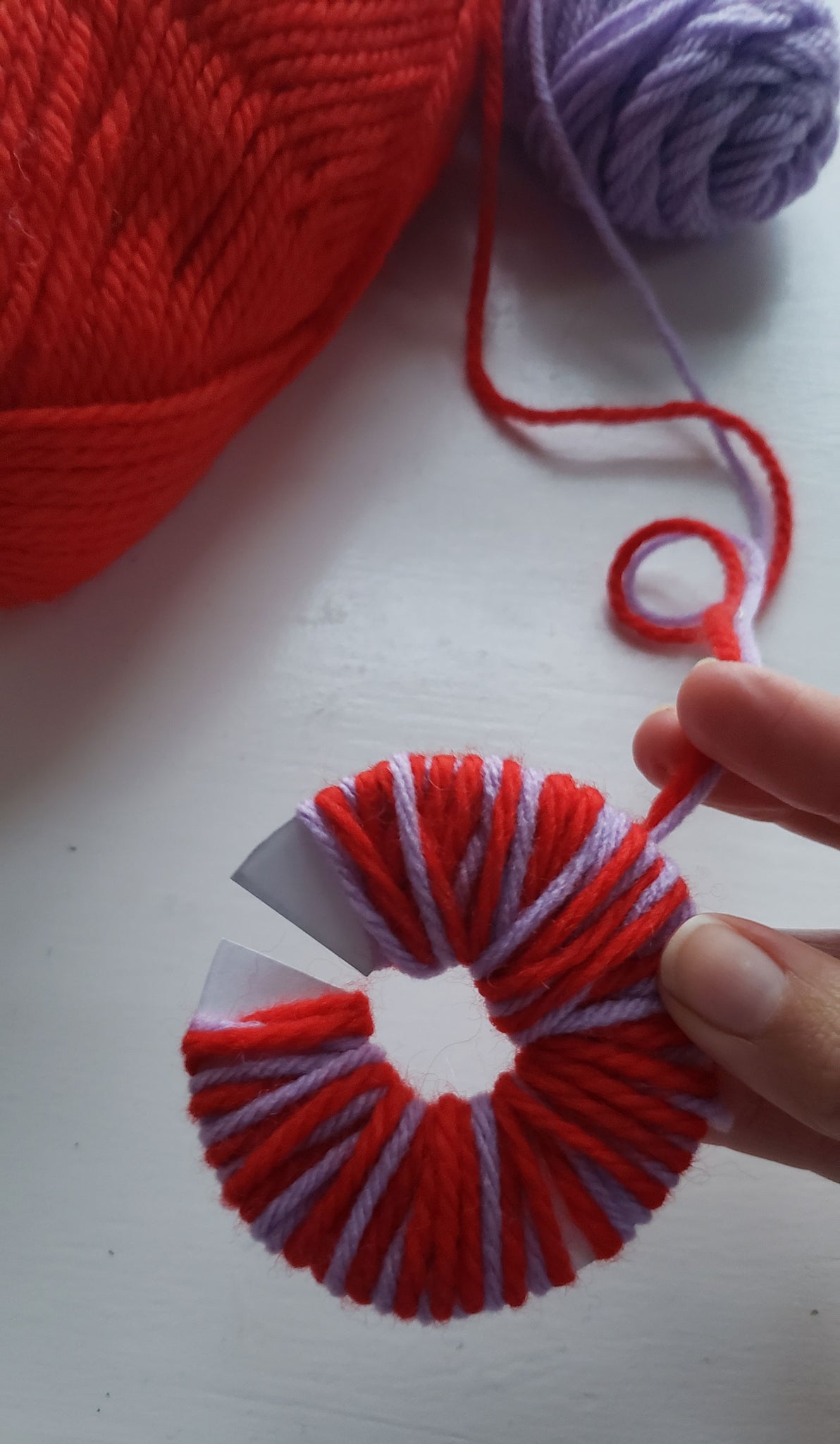 Yarn wrapped around a pom pom circle
