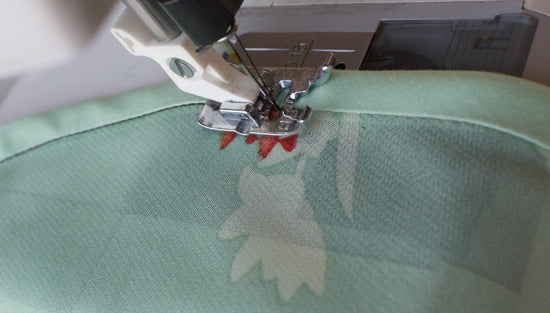 Sewing in the ditch of the seam to secure underside of binding