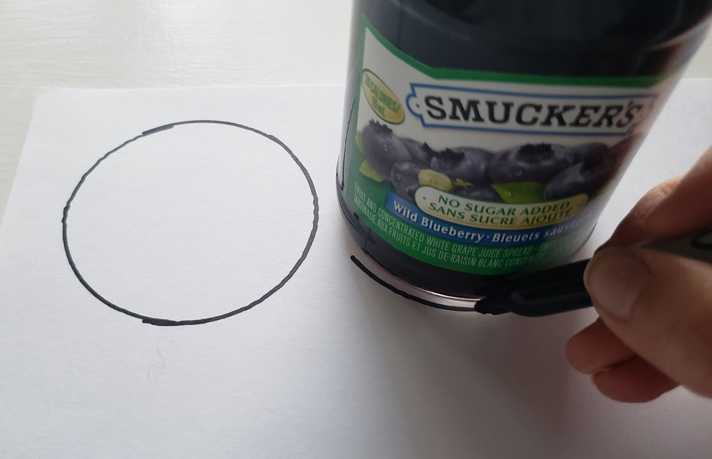 Tracing around the bas of a jar to create two circular shapes